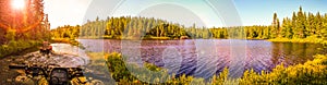 People driving ATV quads through water. Sunset or Sunrise. Lake in Ontario, Canada.