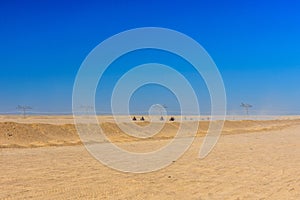 People driving quad bikes during safari trip in Arabian desert not far from the Hurghada city, Egypt