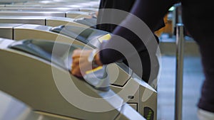 People drop coins into wicket control panel in Subway, pass through Turnstile