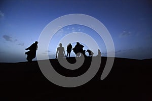 People on dunes of Moroccan desert