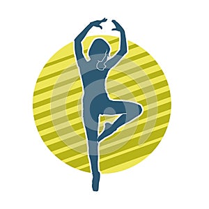 Silhouette of a female ballet dancer in action pose.