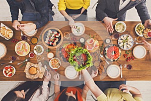 People eat healthy meals at served table dinner party