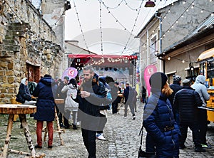 People eat street food and have a hot drink at the Street Food Festival winter edition