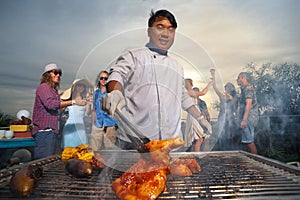 People eating bbq food at the yard at summer sunset