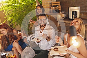 People eating cake at birthday party