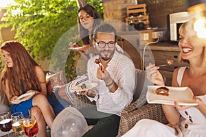 People eating cake at birthday party