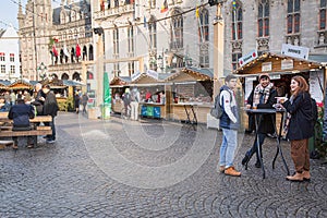 People eating in the Christmas market in Brugge, Belgium