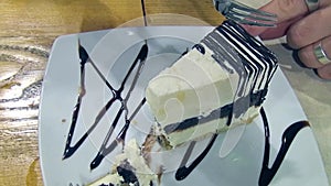 People eating a dish with a slice of cake as dessert.