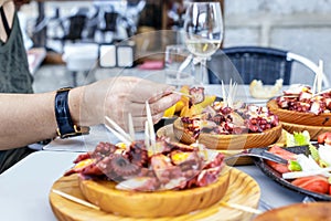 People eating Pulpo a la Gallega with potatoes. Galician octopus dishes. photo