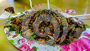 People eating Yong Tau Foo or Yentafu, a Chinese cuisine using plastic fork on a table