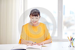 Happy asian young woman student learning at home
