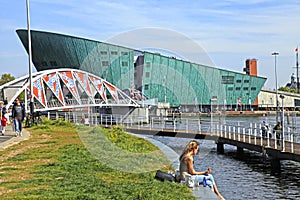 People on embankment near Science Center NEMO, Amsterdam