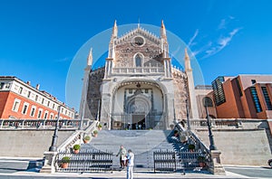 People emerge from an old cathedral church in Madrid, Spain on a beautiful sunny day.