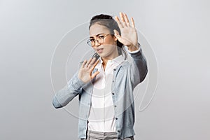 People, emotions and lifestyle concept. Portrait of displeased and disgusted asian woman defending herself from someone