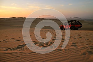 People enjoy dune buggy riding on Huacachina desert in Ica region of Peru, South America