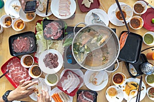 People enjoy eating Shabu Sukiyaki, Japanese food together top view