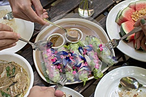 People enjoy eating thai food together, top view