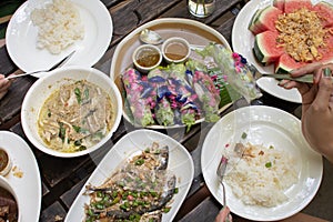 People enjoy eating thai food together, top view