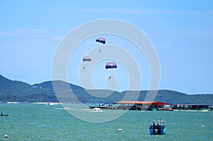 People enjoy parasailing on the blue sea, Gulf of Thailand, Pattaya beach, Thailand