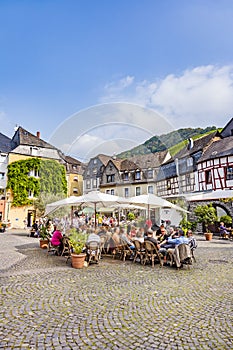 people enjoy the summer day at market place with medival half timbered houses in Bernkastel-Kues