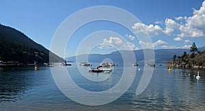 People are enjoying boating and swimming in Okanagan lake, Vernon, BC, Canada.