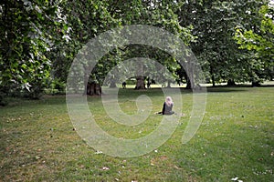 People enjoying fresh air in Green Park , London , England