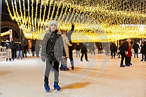 People enjoying ice skating during beautiful winter in the center of city. Merry Christmas and Happy New Year. Holiday