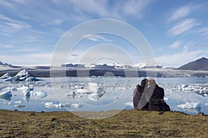 People enjoying the icebergs in Iceland