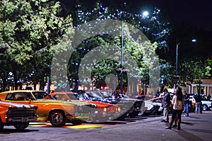 People enjoying Modern, rare, fancy and classic cars and concert on the plaza in Santa Fe New Mexico leading up to Zozobra