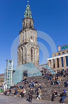 People enjoying the spring sun in front of the Martini tower