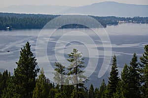 People Enjoying Summer Lake in the Mountains