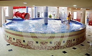 People enjoying water slide at pool