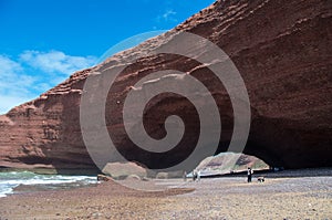 People enjpying beautiful day at Legzira beach with famous rock formation