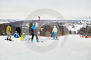 People equipped for skiing and snowboarding on the photo
