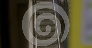 people on the escalator going down. escalator going down