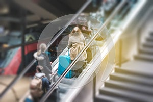 People on escalator in train station, travel concept motion blur