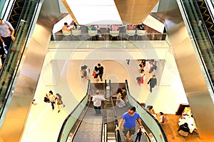 People on escalators in a shopping mall