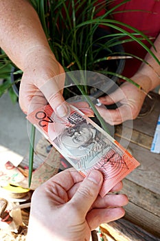 people exchanging money and shaking hands