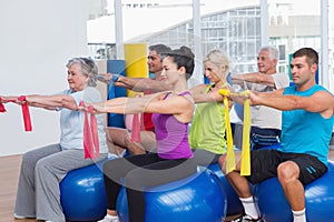 People exercising with resistance bands in gym