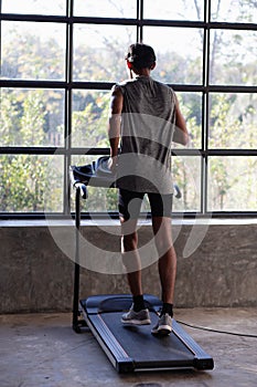 People exercising on a treadmill use it with a VR goggles headset