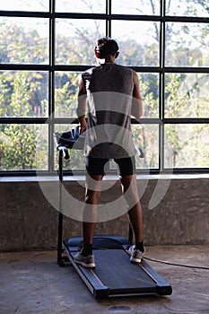 People exercising on a trePeople exercising on a treadmill use it with a VR goggles headsetadmill use it with a VR goggles headset