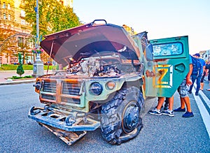 People explore bombed and burnt Tigr multipurpose all-terrain infantry mobility vehicle, Kyiv, Ukraine