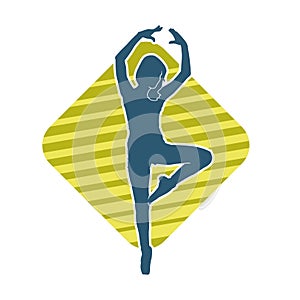 Silhouette of a female ballet dancer in action pose.