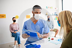 People with face mask getting vaccinated, coronavirus, covid-19 and vaccination concept.