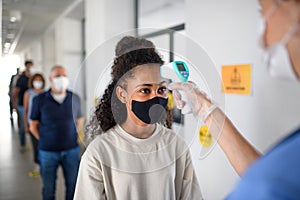 People with face masks, coronavirus, covid-19, measuring temperature and vaccination concept.