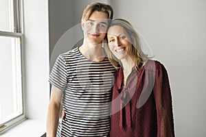 A people and family happy teen boy with mother at home
