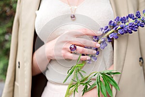 People, fashion, jewelry and luxury concept, closeup of woman wearing luxury jewelry standing on the street. Color