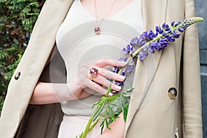 People, fashion, jewelry and luxury concept, closeup of woman wearing luxury jewelry standing on the street. Color