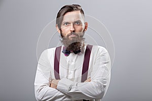 People, fashion and style concept - close-up portrait of young hipster on grey background