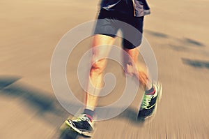 People feet on city road in marathon running race